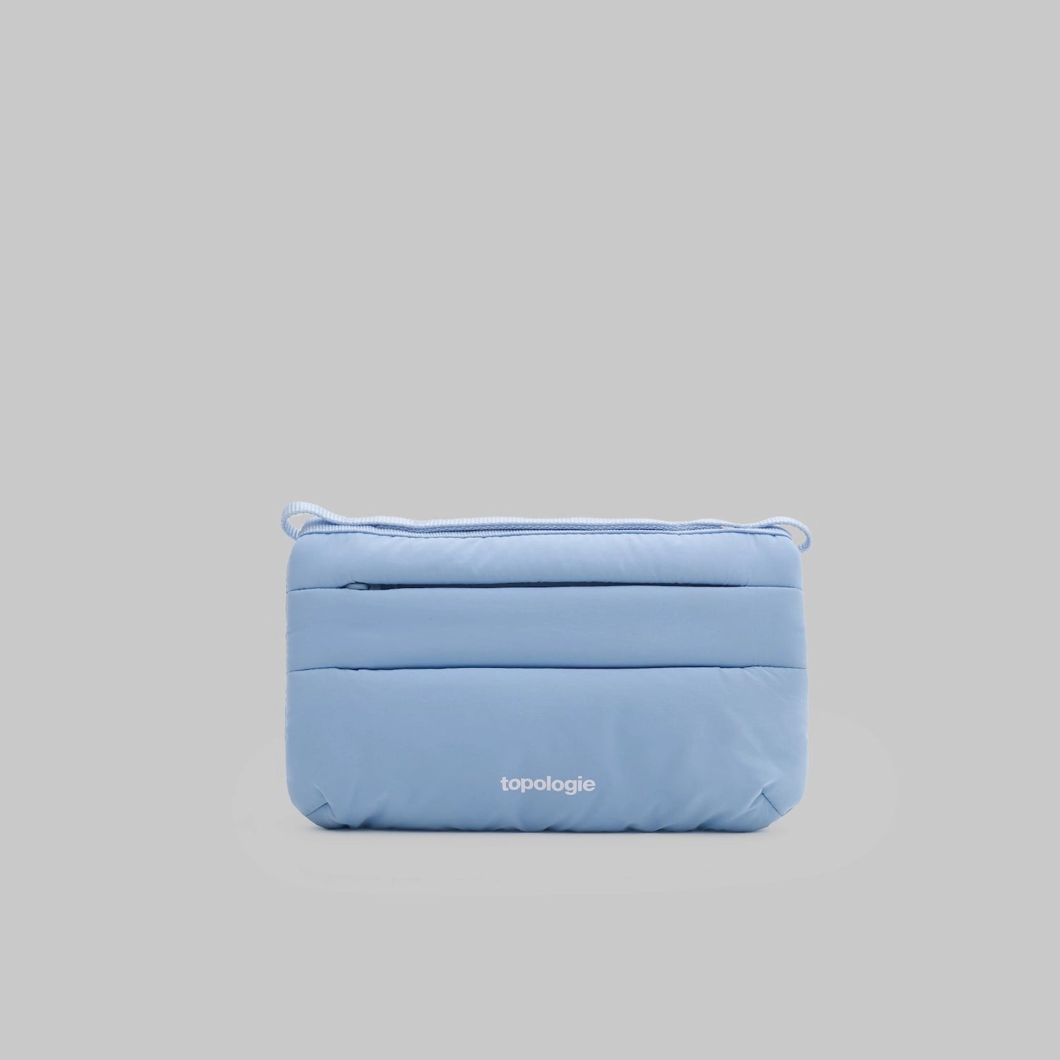 Phone Sacoche 90 Chambray Silky Peach Bag in light blue with zip compartments and Topologie branding.