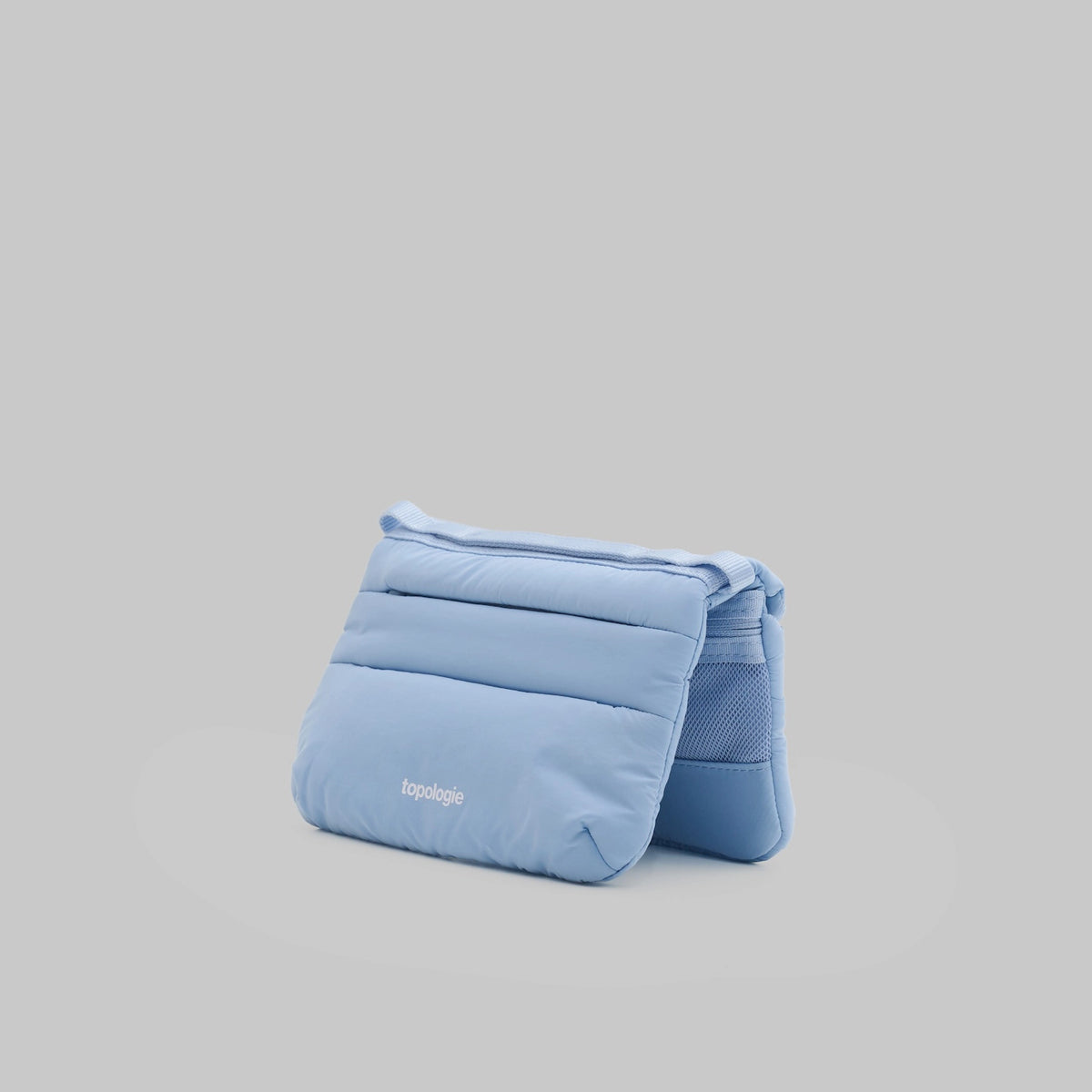 Phone Sacoche 90 Chambray Silky Peach Bag in soft blue, showcasing sleek design and functional compartments.