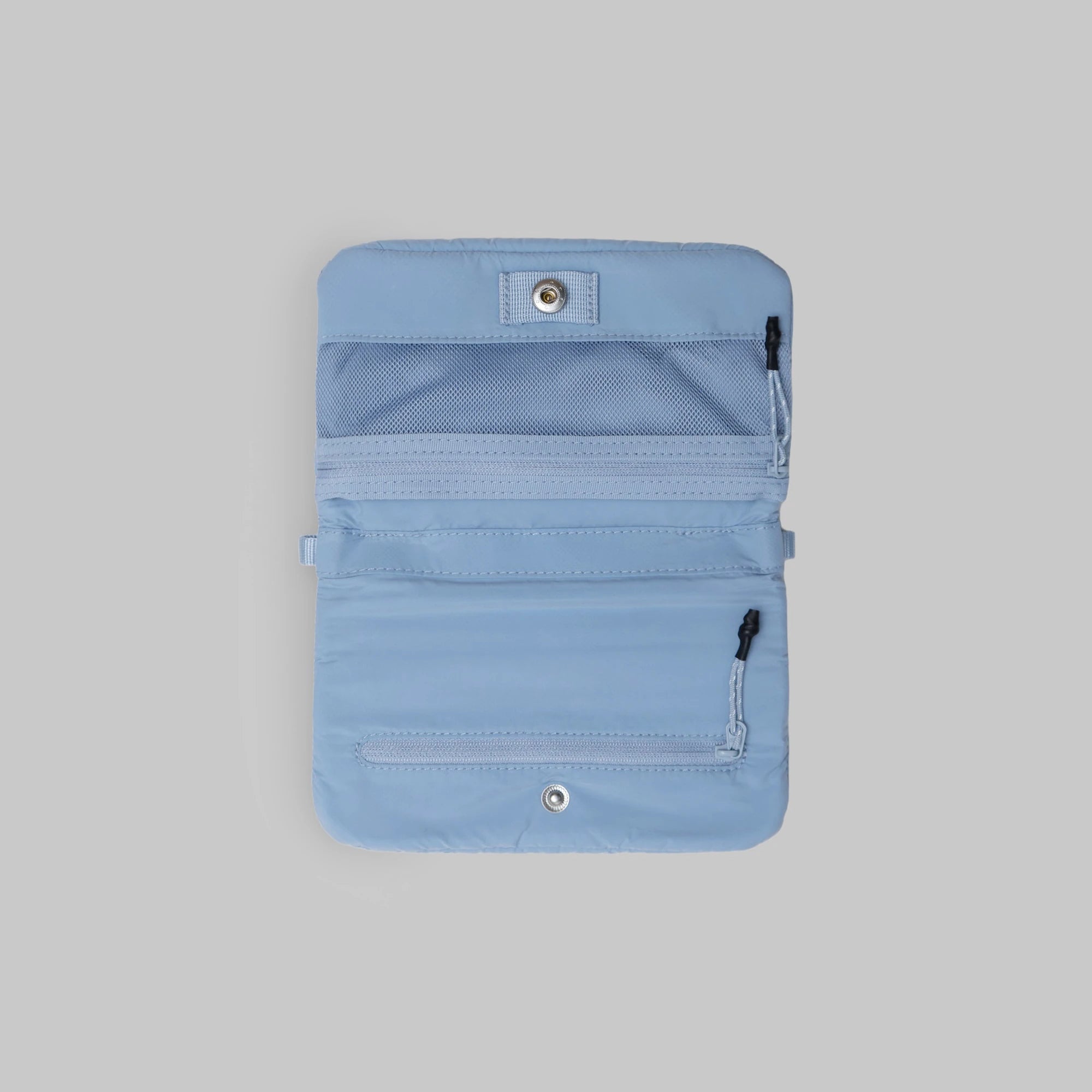 Phone Sacoche 90 Chambray Silky Peach Bag interior with multiple zipped compartments in light blue color.