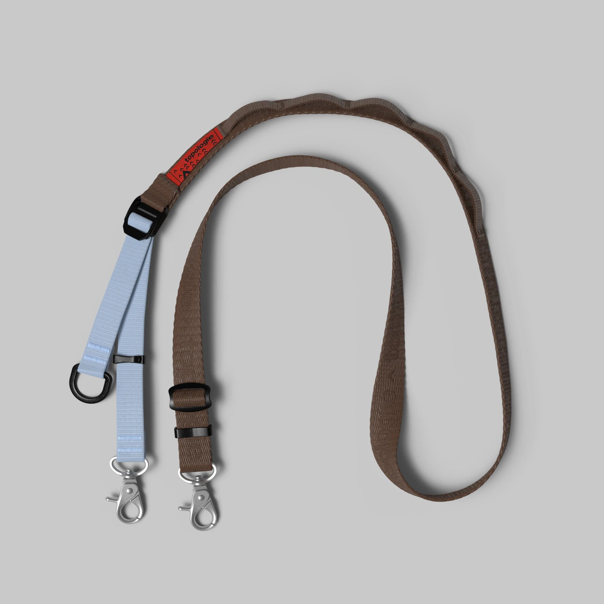 Utility Sling Cocoa Strap featuring adjustable lengths and durable nylon material.