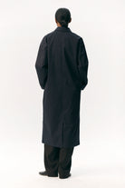 Rear view of Janice B Navy Coat showcasing its stylish design and practicality.