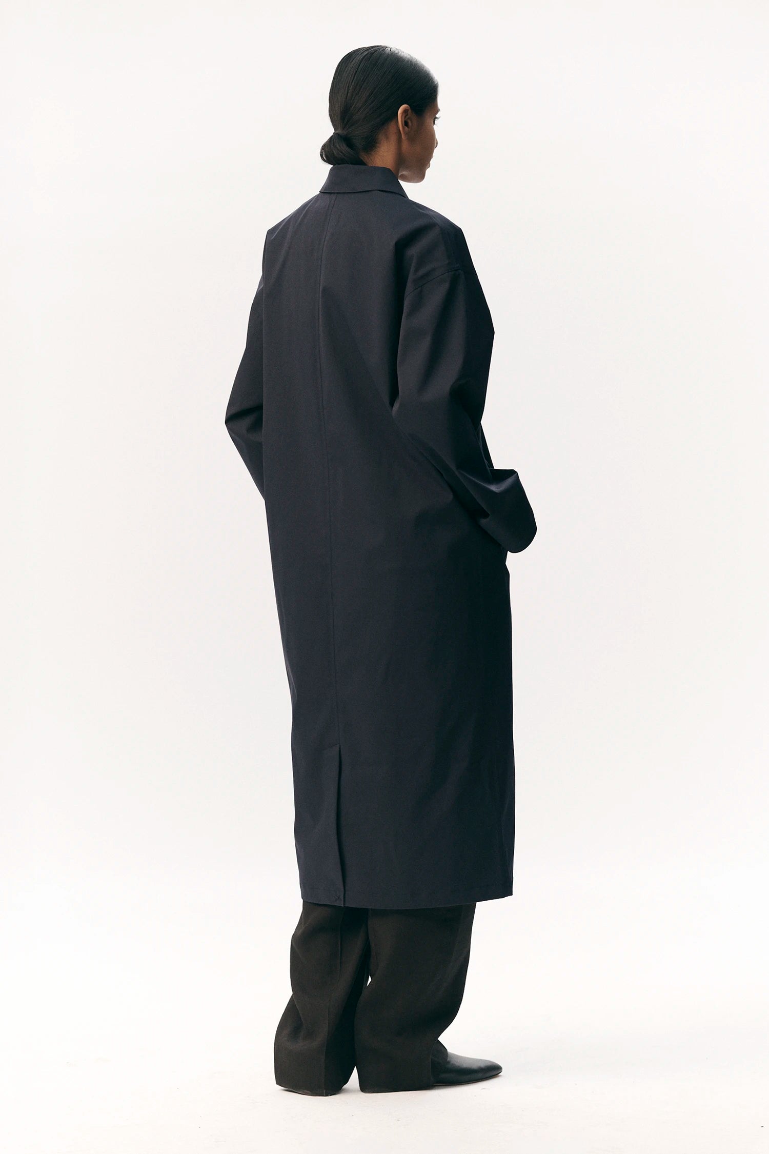 Back view of Janice B Navy Coat, a waterproof and breathable jacket designed for spring, summer, and autumn.