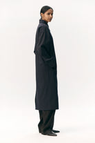 Janice B Navy Coat worn by model, showcasing waterproof and breathable fabric in a stylish silhouette.