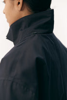 Close-up of the collar of the Janice B Navy Coat, showcasing its stylish design and waterproof material.
