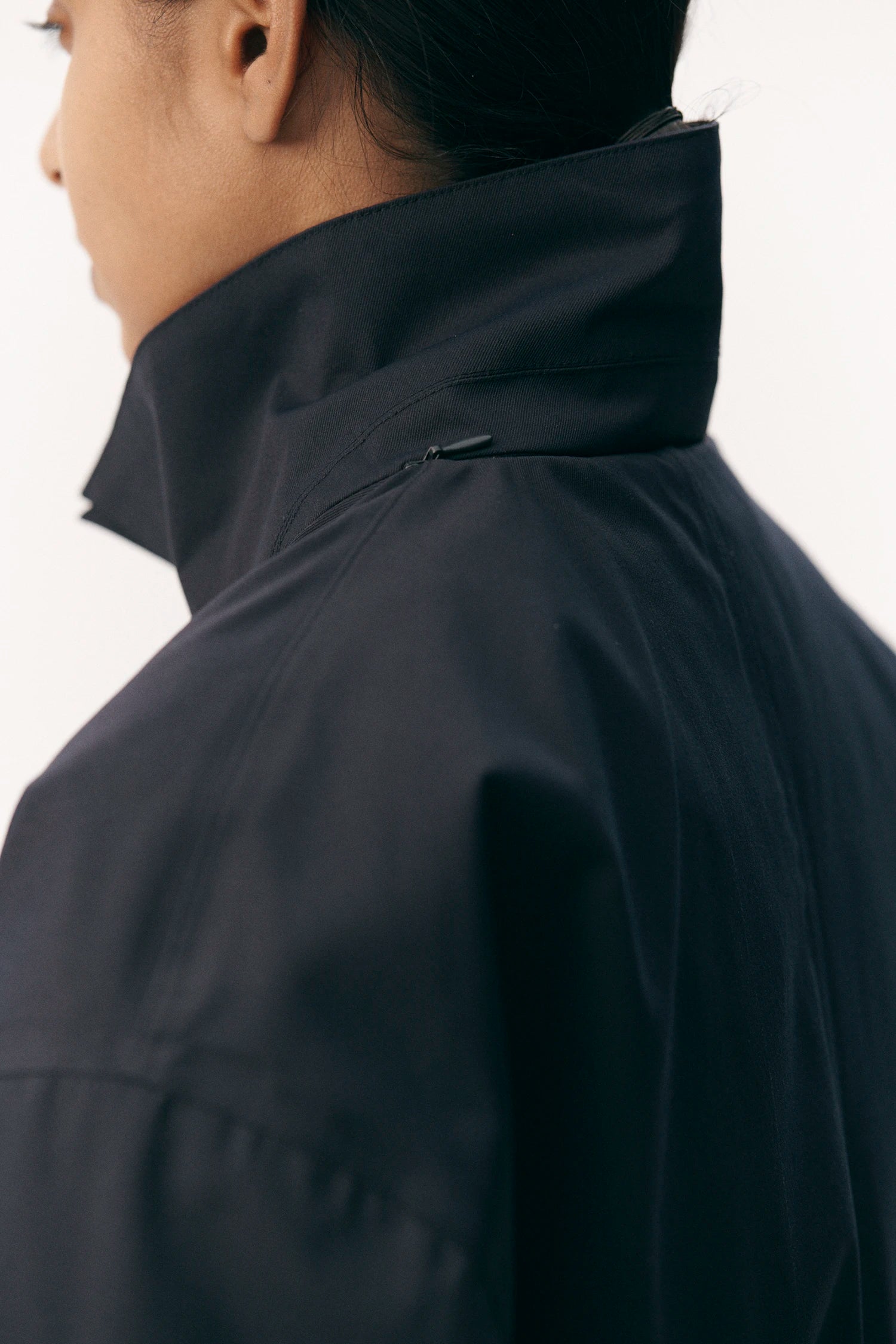 Close-up of the collar of the Janice B Navy Coat, showcasing its stylish design and waterproof material.