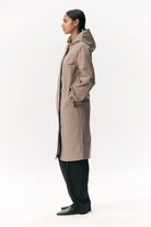 Model wearing Not So Long Tube Stretch Twill Light Army Parka in a side view, showcasing its stylish and functional design.