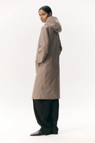 Model wearing Not So Long Tube Stretch Twill Light Army Parka in light army color, showcasing adjustable hood and breathable fabric.