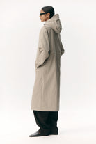 Roomy Long Tube Nylon Light Army Coat displayed on model in profile, showcasing adjustable hood and lightweight fabric.