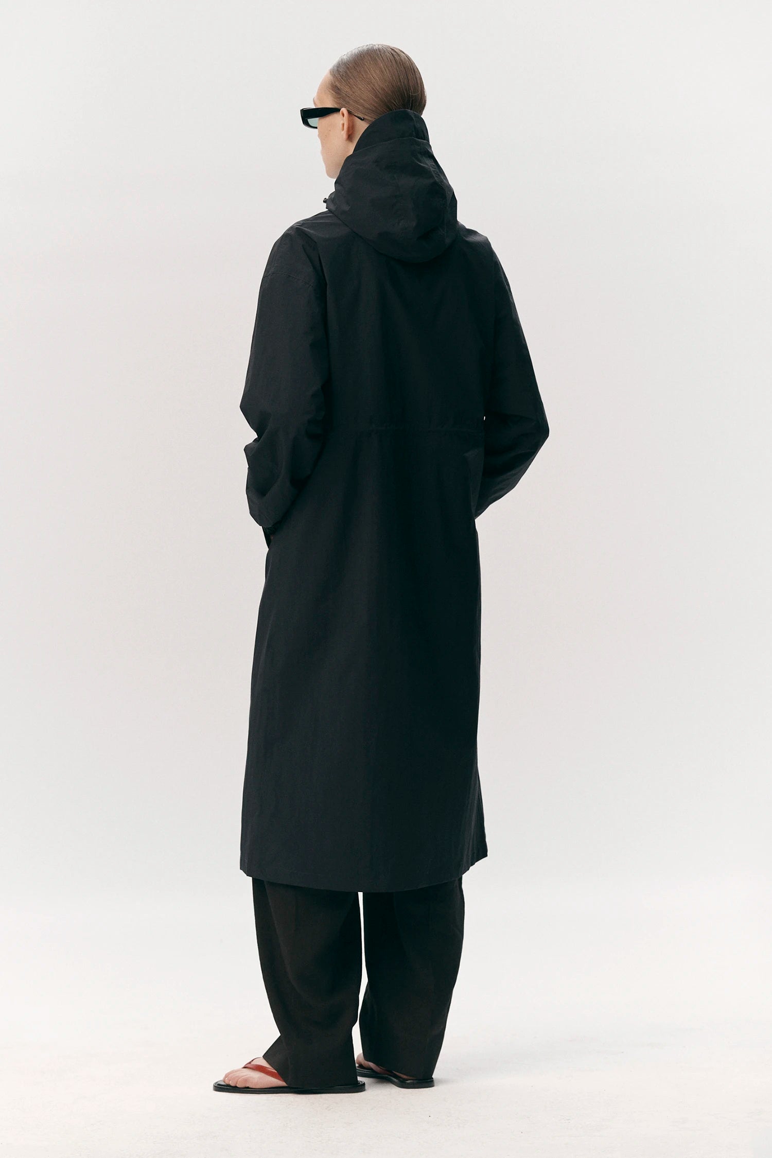 Roomy Long Tube Nylon Navy Coat back view on model, showcasing adjustable hood and lightweight design.