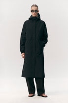 Roomy Long Tube Nylon Navy Coat on a model, showcasing its waterproof and breathable features.