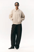 Short Tracker WM Nylon Beige Jacket worn by model, showcasing its lightweight and comfortable design.