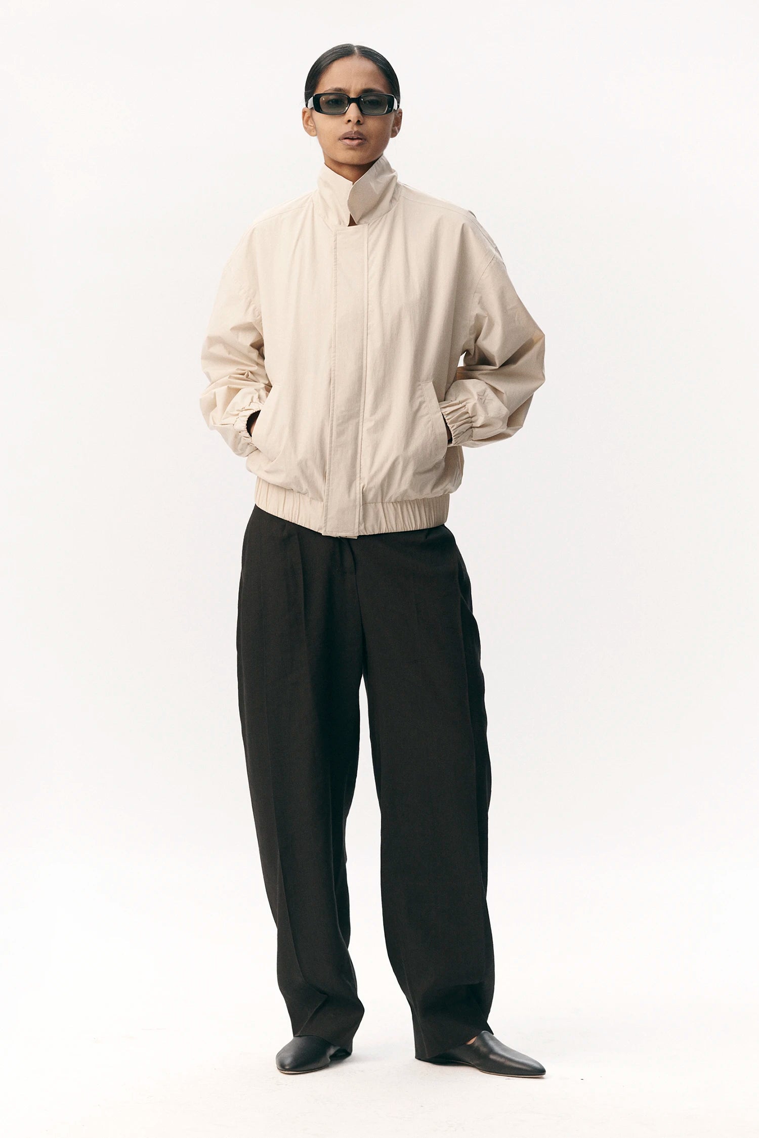 Model wearing a Short Tracker WM Nylon Beige Jacket, showcasing its oversized fit and stylish design.