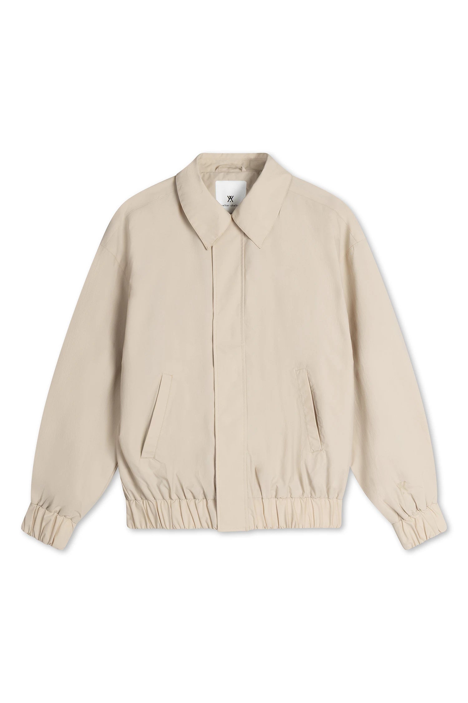 Short Tracker WM Nylon Beige Jacket, a lightweight unisex bomber in beige with elastic waistband and roomy fit.
