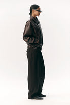 Short Tracker WM Dark Chocolate Jacket worn by a model, showcasing its stylish bomber design and roomy fit.