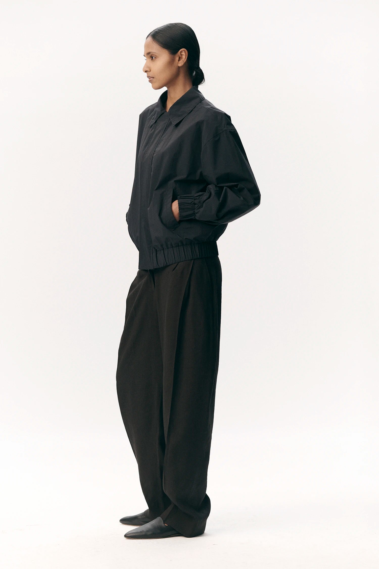 Short Tracker WM Nylon Navy Jacket displayed on a model in a side view, showcasing its comfortable fit and stylish design.