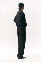 Short Tracker WM Nylon Navy Jacket shown in a side view, featuring a relaxed fit and stylish design.