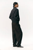 Model wearing Short Tracker WM Nylon Navy Jacket featuring a relaxed fit and stylish design.