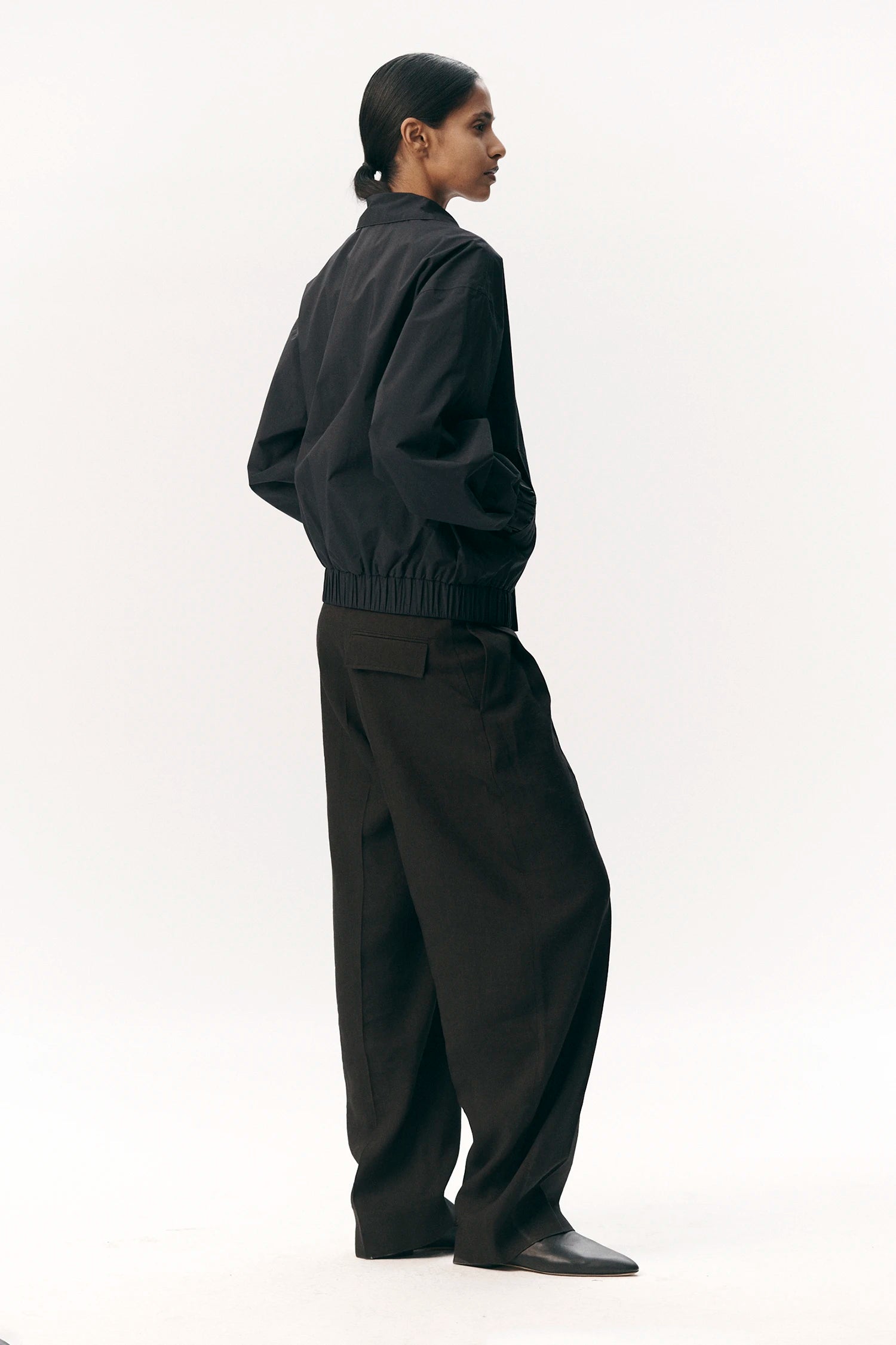 Model wearing Short Tracker WM Nylon Navy Jacket featuring a relaxed fit and stylish design.