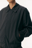 Short Tracker WM Nylon Navy Jacket worn by model, showcasing its lightweight and breathable design.