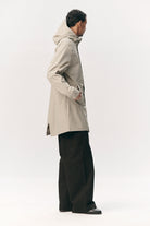Model wearing a Terror Weather Nylon Light Army Coat in beige, showcasing its stylish and functional design.