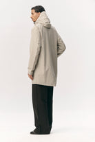 Model wearing a Terror Weather Nylon Light Army Coat from the back, showcasing its adjustable hood and lightweight design.