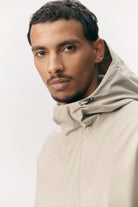 Man wearing Terror Weather Nylon Light Army Coat with adjustable hood and double zip closure.