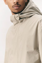 Close-up of a model wearing the Terror Weather Nylon Light Army Coat with an adjustable hood.