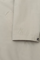 Detail of the sleeve of the Terror Weather Nylon Light Army Coat showing logo and material.