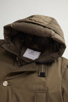 Arctic Parka Dark Green Coat with protective hood and ribbed concealed cuffs by Woolrich.