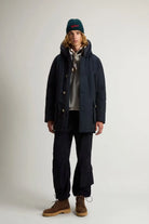 Model wearing Arctic Parka Melton Blue Coat, a premium down filled parka for warmth and style.