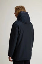 Arctic Parka Melton Blue Coat shown from the back, featuring a protective hood and premium down fill.