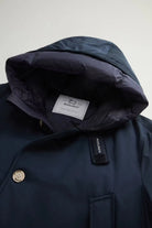 Arctic Parka Melton Blue Coat showcasing inner hood and label from Woolrich.
