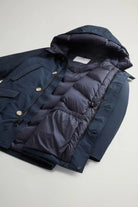 Arctic Parka Melton Blue Coat showcasing premium down filling and protective hood.