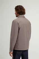Back view of a man wearing the Cloud Overshirt Falcon by Woolrich in a stylish, water-resistant design.