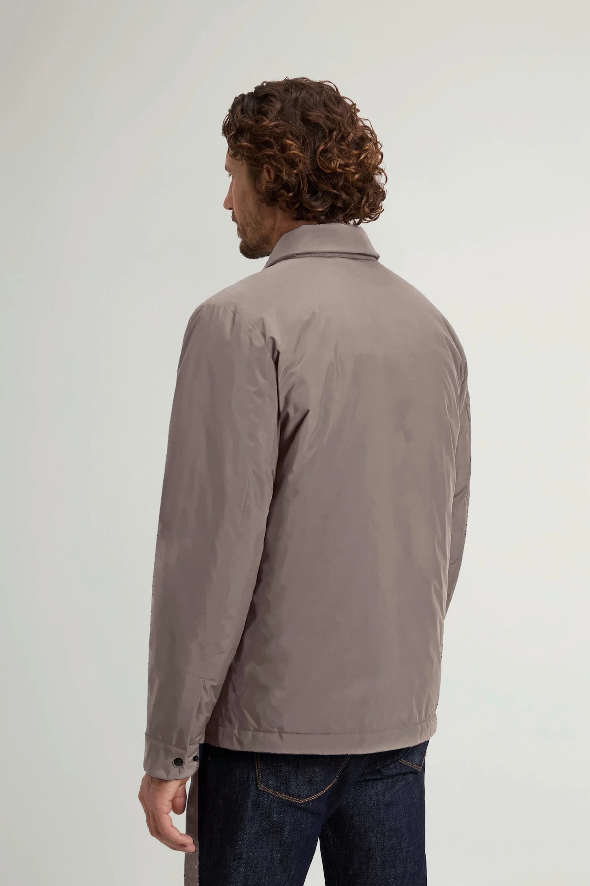 Back view of a man wearing the Cloud Overshirt Falcon by Woolrich in a stylish, water-resistant design.