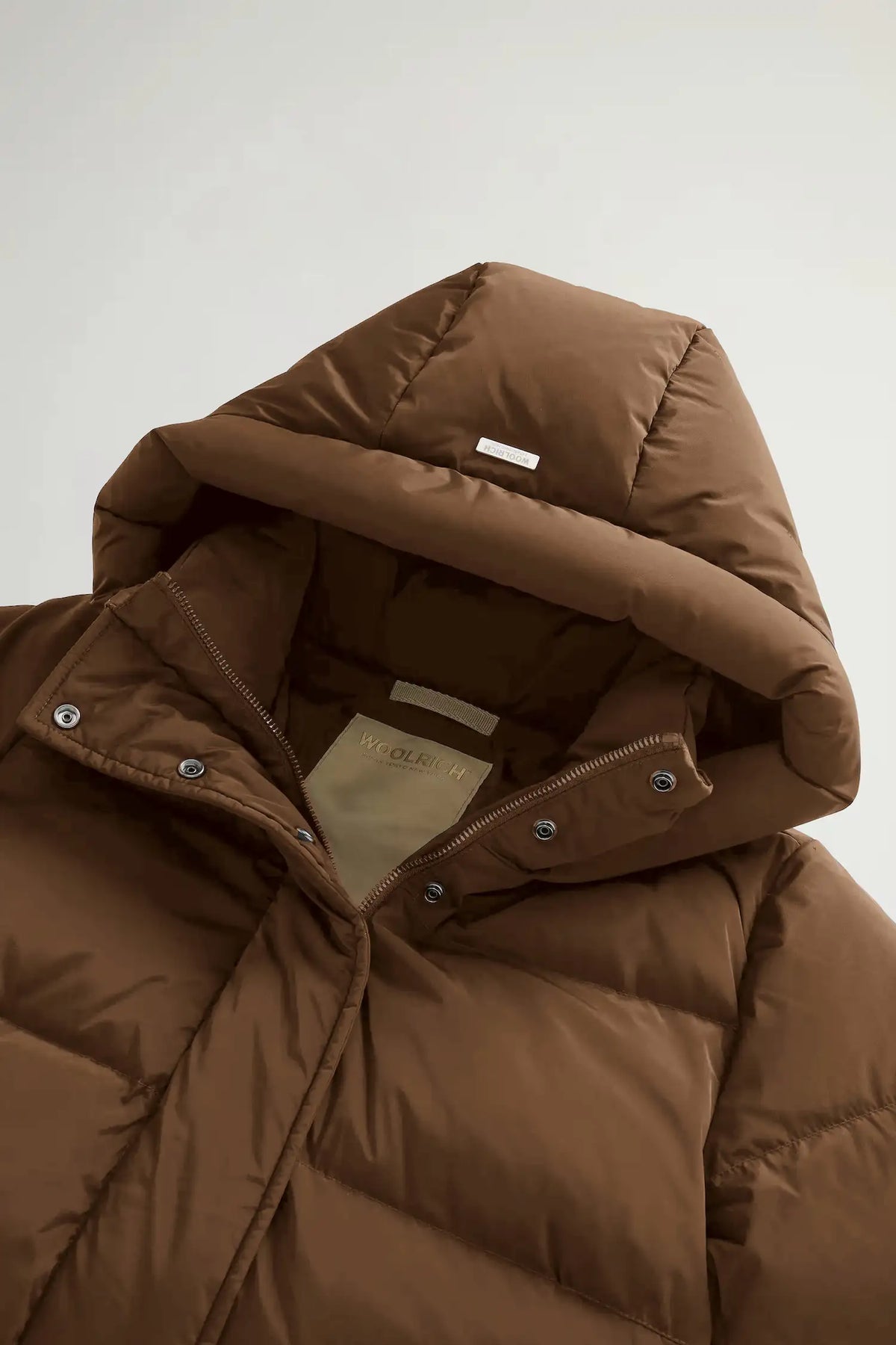 Kelly Jacket Dark Earth Coat by Woolrich featuring a cozy, down-filled brown hooded design.