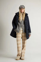 Woman wearing Kelly Jacket Melton Blue Coat, styled with gray sweater, plaid trousers, and a cap.