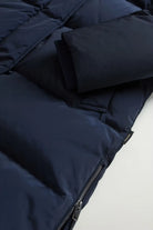 Kelly Jacket Melton Blue Coat close-up showing premium down filling, zipper, and ribbed cuff detail.