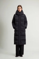Model wearing a stylish Kelly Long Parka Black Coat, showcasing its premium down fill and sleek design.