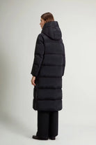 Kelly Long Parka Black Coat shown from behind, featuring a removable hood and premium down filling.