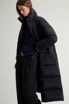 Kelly Long Parka Black Coat displayed on a model, featuring a premium down filled design and stylish silhouette.