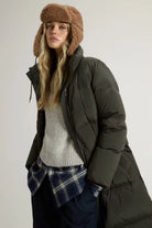 Model wearing the Kelly Long Parka Dark Green Coat with a cozy hat and casual sweater.