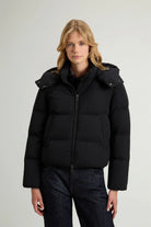 Madison Jacket Black Coat model wearing a premium down filled jacket with removable hood and side pockets.