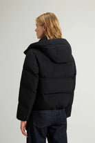 Woman wearing Madison Jacket Black Coat, a premium down filled jacket with removable hood.
