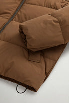 Madison Jacket Dark Earth Coat by Woolrich, showcasing premium down filling and lightweight Matt Stretch Nylon.