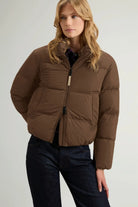 Madison Jacket Dark Earth Coat by Woolrich model wearing a premium down filled jacket in dark earth color.
