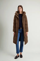 Model wearing Madison Long Coat Dark Earth Coat by Woolrich, showcasing its stylish design and premium down fill.