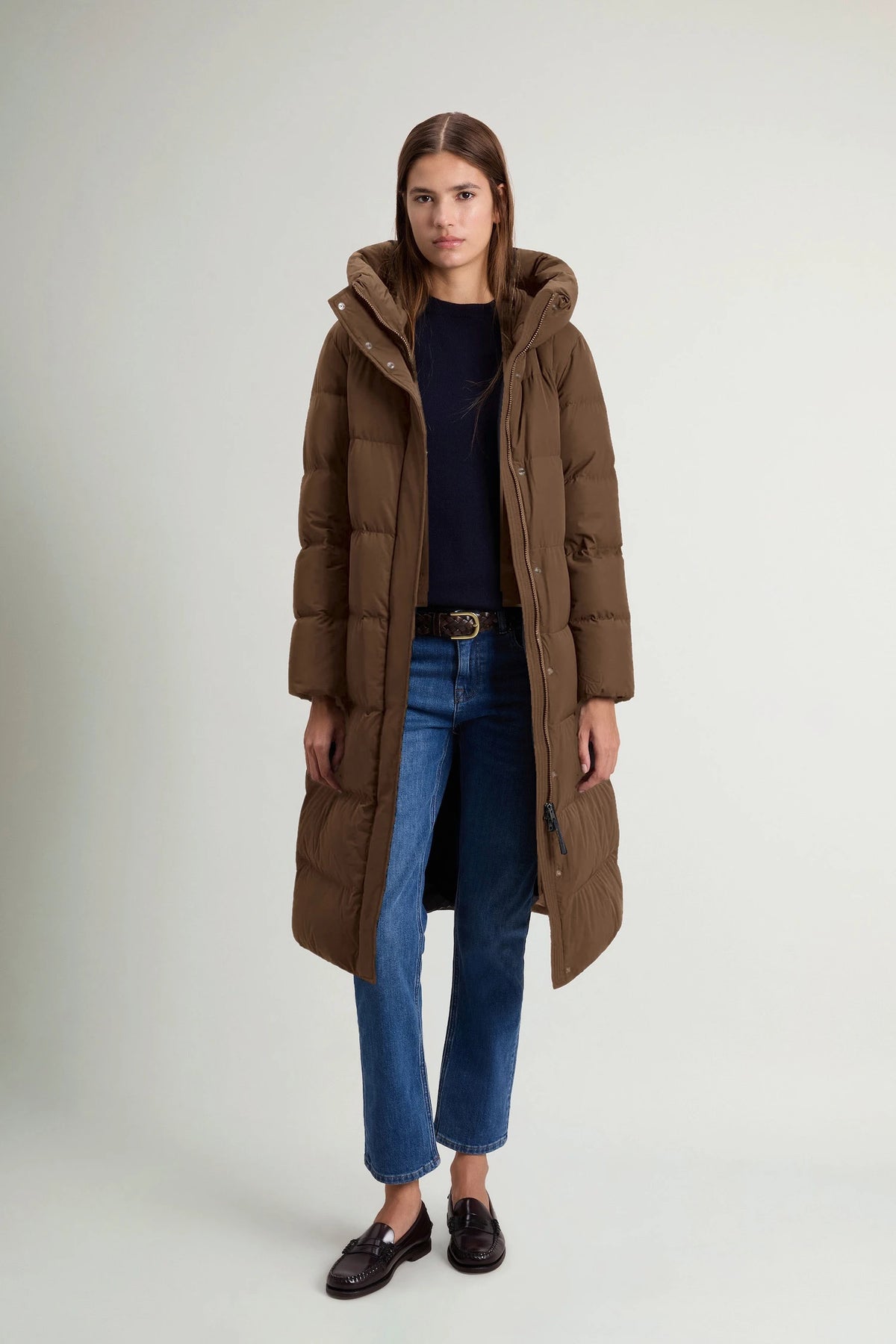 Model wearing Madison Long Coat Dark Earth Coat by Woolrich, showcasing its stylish design and premium down fill.