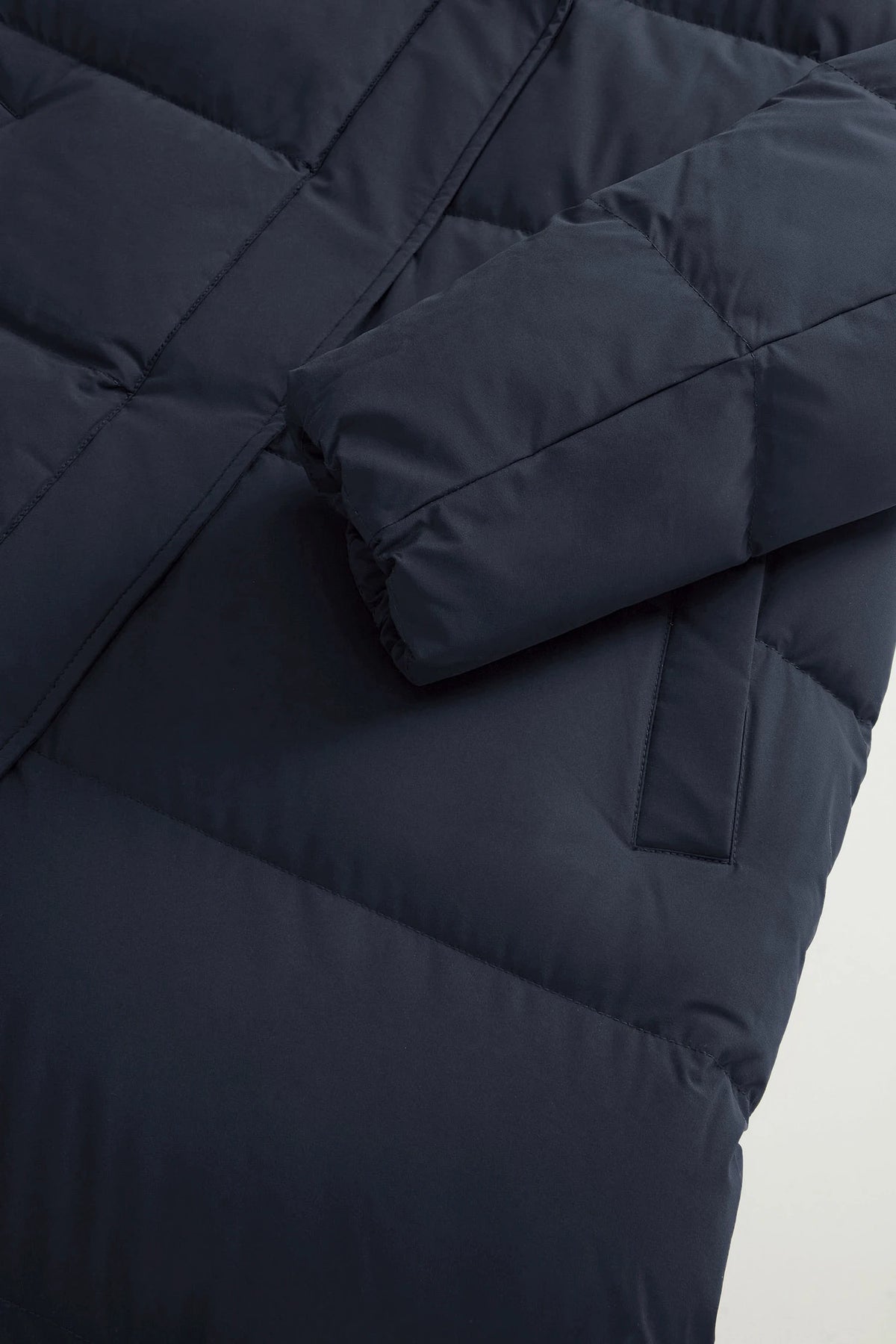 Madison Long Coat Melton Blue Coat by Woolrich, showing the padded sleeve and body in navy blue.