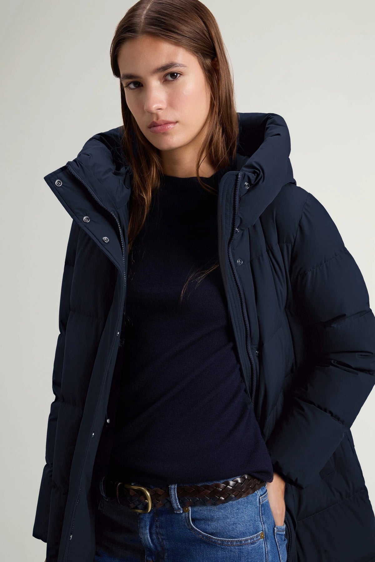 Model wearing the Madison Long Coat Melton Blue Coat by Woolrich, showcasing its stylish down-filled design and protective features.